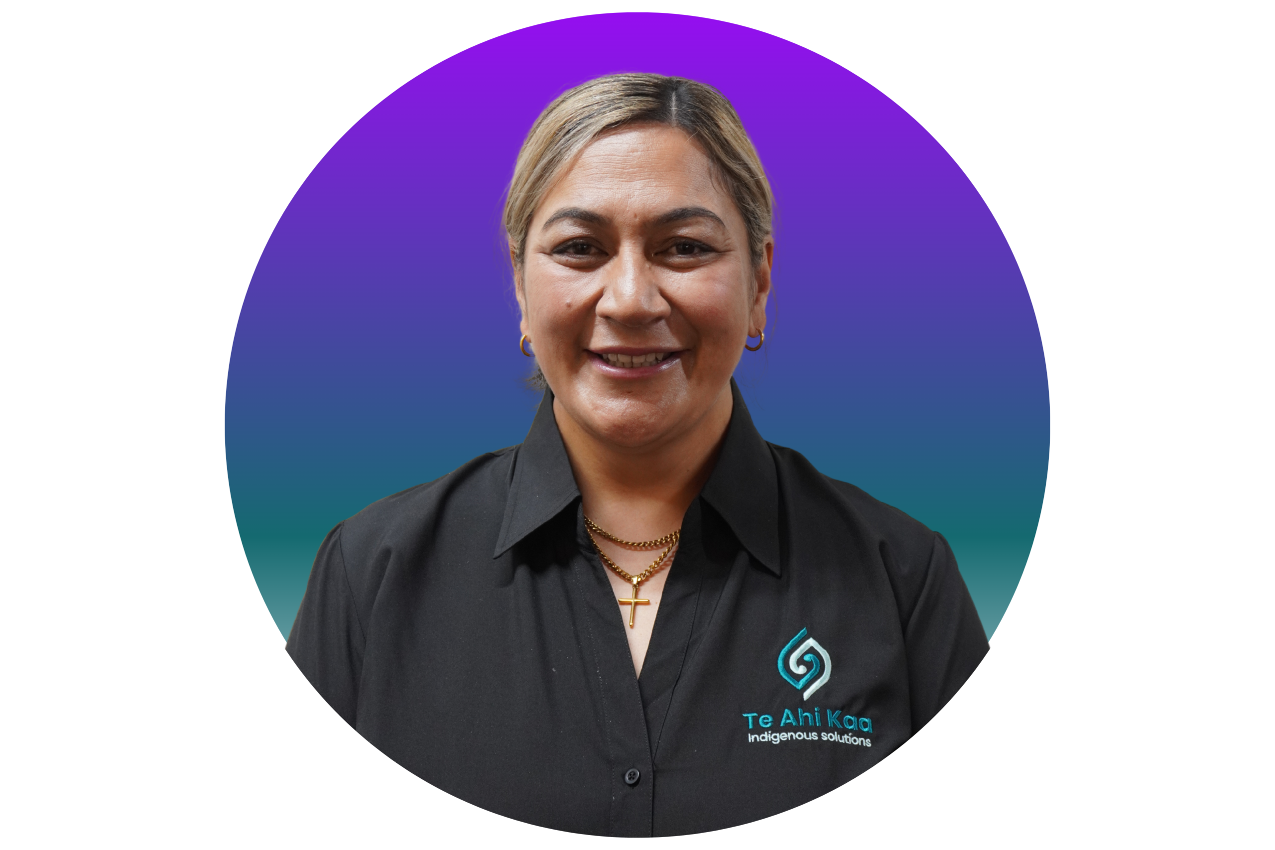 Candice is in her 40s; her hair with blonde highlights is tied back neatly, she is wearing a necklace and a black shirt with a Te Ahi Kaa logo.